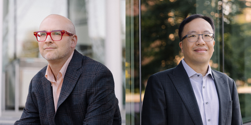 Matt Lucas (left), a man in red glasses looking into the distance, and David Poon (right), a man wearing a black suit and black glasses, facing front. Photographed by Albert Law, 2022